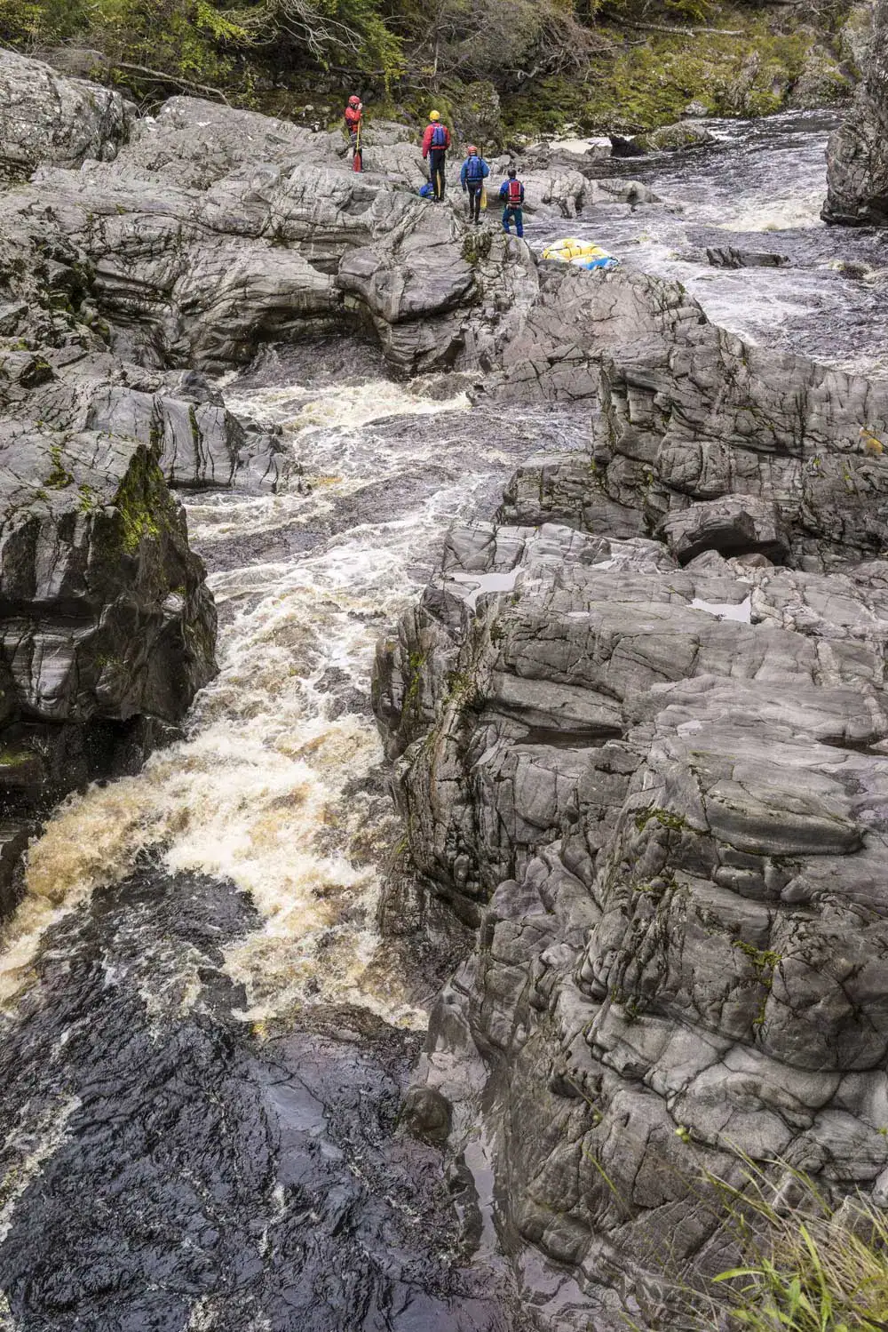 Rocky gorge at Randolphs Leap with white water rushing between cliffs and walkers on the rocks above