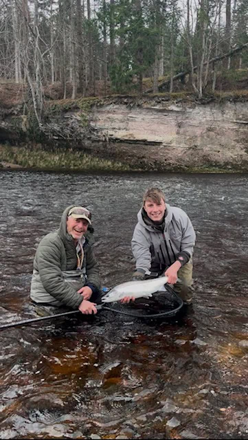 Freddie and his father Henry holding a spring salmon caught on the Altyre beat of the River Findhorn with Ian Neale, The Speycaster